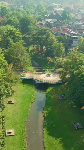 Aerial view of lush urban park canal surrounded by greenery