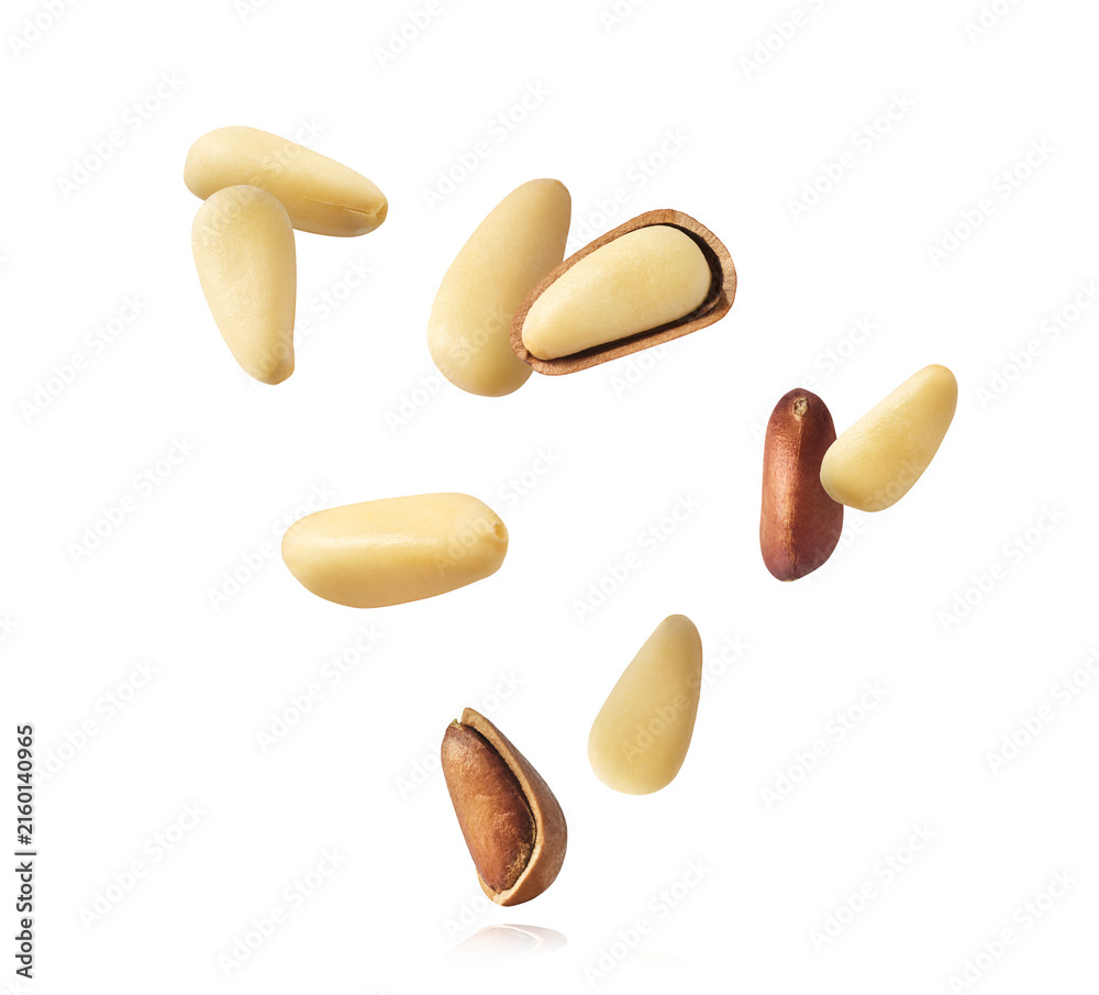 Fototapeta premium Fresh raw pine nuts flying in the air isolated. Food levitation concept.