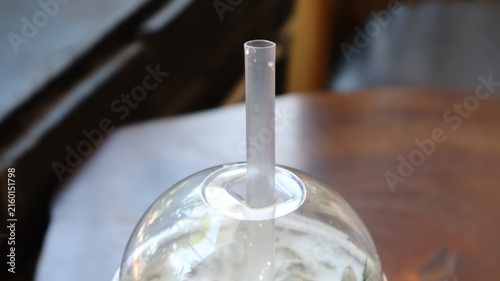 Plastic straw in a dome lid of an iced drink
