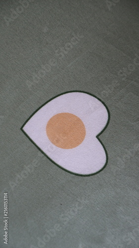 Heart shaped fried egg on fabric