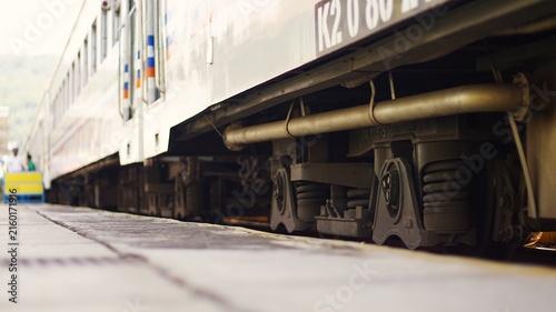 Принти на полотні Low angle close-up of a passenger train undercarriage and bogie wheels at a stat