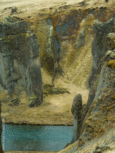Moss-covered volcanic rock formations in Icelandic canyon