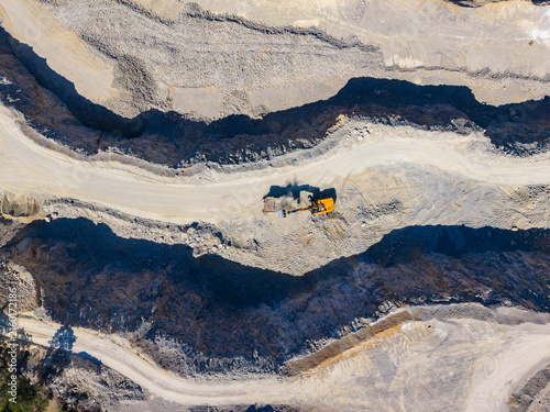 Obraz na płótnie Construction activity happens in a mine, where large machines move dirt and rock