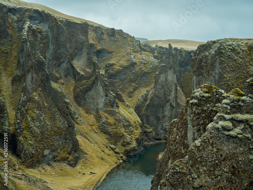 Moss-covered volcanic rock formations in Icelandic canyon