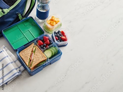 Colorful packed lunch with berries sandwich and fresh snacks