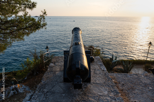 Принти на полотні An ancient artillery cannon, once used for coastal defense, now a decorative relic on seaside promenades