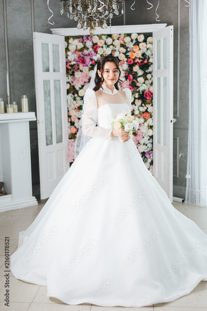 Fototapeta premium Young Bride Posing in Elegant White Wedding Dress – Bridal Portrait, Romantic Wedding Photoshoot and Bridal Fashion