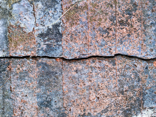 Cracked granite stone surface with weathered texture building construction