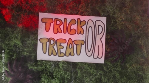Trick or Treat graphic text popping onto foggy moss in lightning