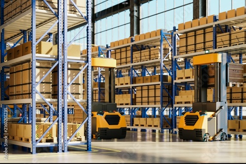 Obraz na plátne Automated guided vehicles moving cargo in modern high bay warehouse with tall st