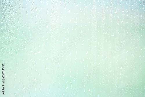Light green gradient raindrops on glass abstract blurred background gentle summer soft green