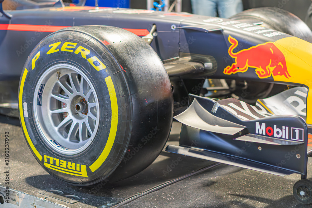 Naklejka premium Indoor display of a Formula 1 car, featuring Red Bull Racing livery and Pirelli tires Viewed from three-quarter angle, showing left side, front wheel, and underside - Kyiv, Ukraine - June 7, 2025