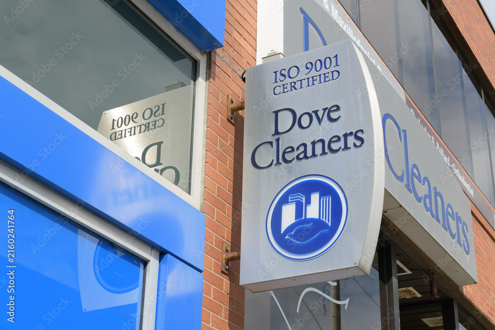 Fototapeta premium exterior building facade and sign of Dove Cleaners, a dry cleaner, located at 1560 Yonge St, Delisle Court, Toronto