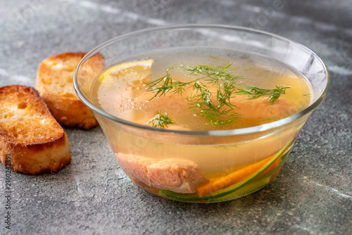 Healthy Nordic Clear Salmon Soup With Fresh Dill Lemon And Vegetables In Glass Bowl