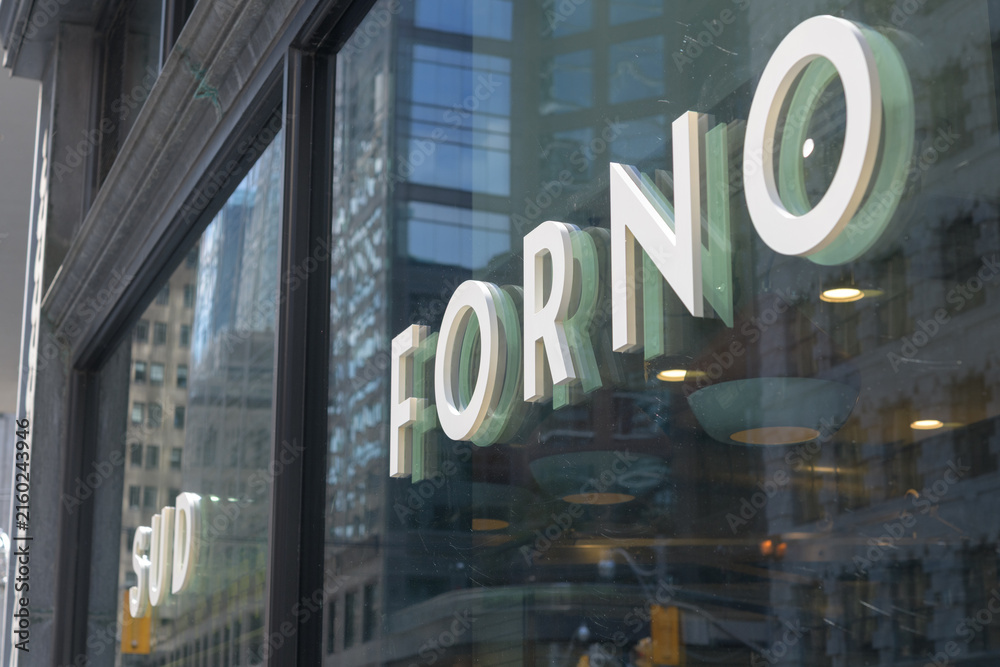 Naklejka premium sign mounted to display windows at Sud Forno, a restaurant, located at 132 Yonge St, Toronto