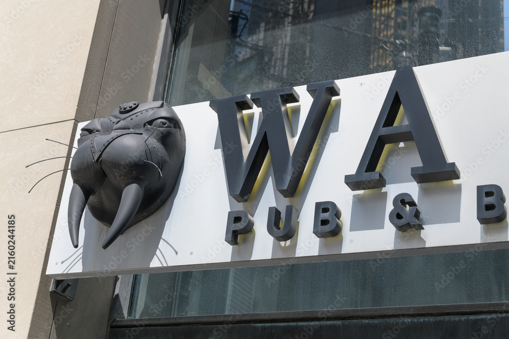 Naklejka premium exterior building facade and novelty sign outside Walrus Pub & Beer Hall, a restaurant, located at 187 Bay St, Toronto