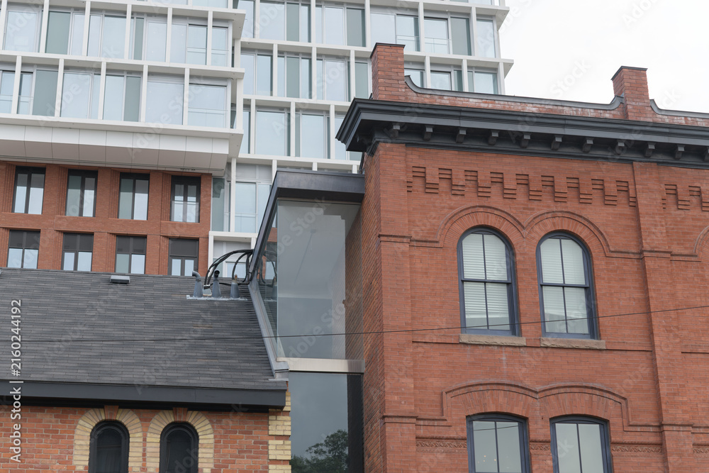 Fototapeta premium shops of Summerhill, 1095-1103 Yonge St, originally constructed c 1892, commercial row buildings contrast with The James, a condominium complex, in Toronto