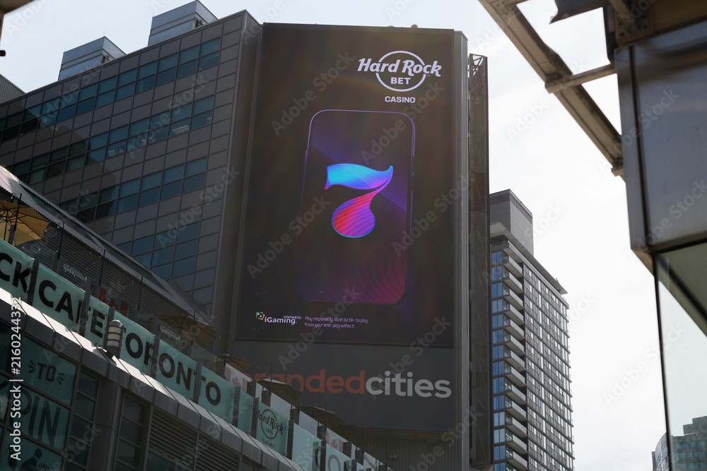 Fototapeta premium electronic billboard featuring ad for Hard Rock Bet on the exterior of The Tenor a shopping mall near Sankofa Square, Toronto
