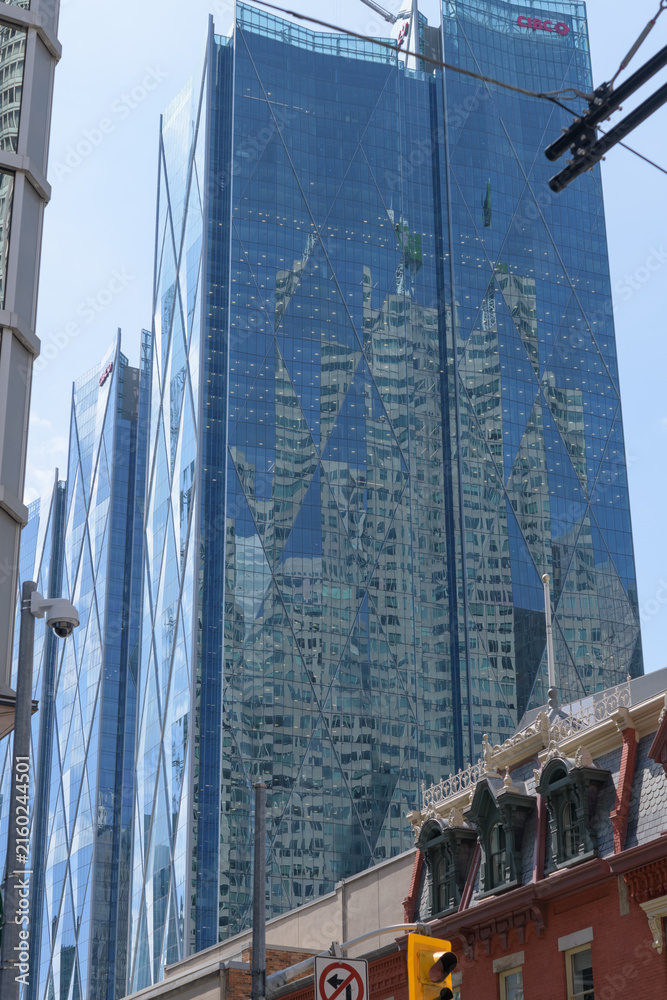 Fototapeta premium north elevation of CIBC Square, designed by WilkinsonEyre + Adamson Associates, in a neo-futurist, commercial high-rise, completed 2021/25, located at 81 and 141 Bay St, Toronto