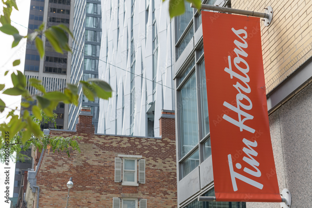 Fototapeta premium wall-mounted projecting banner of Tim Hortons, a coffee shop chain, located here at 18 Yorkville Av and Yonge St, Toronto