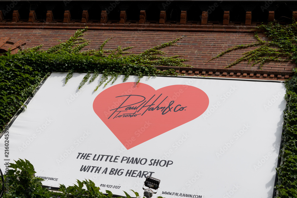 Fototapeta premium sign outside Paul Hahn & Co, a piano store, located at 1058 Yonge St, Toronto (the little piano shop with the big heart)
