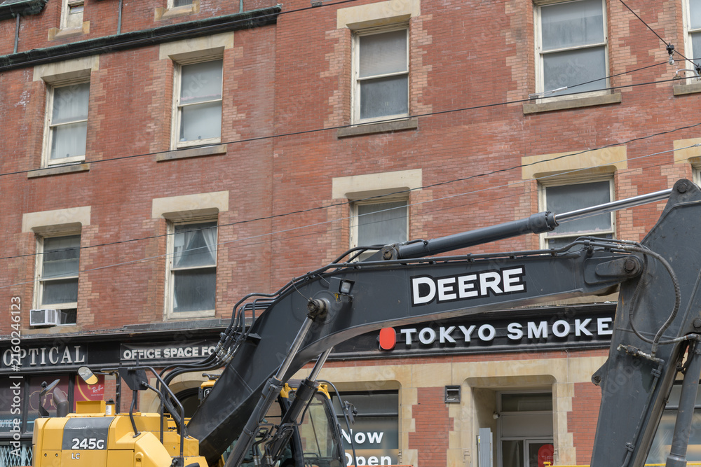Naklejka premium construction work at College St near Yonge in Toronto featuring Deere heavy equipment and Tokyo Smoke Cannabis (450 Yonge St)