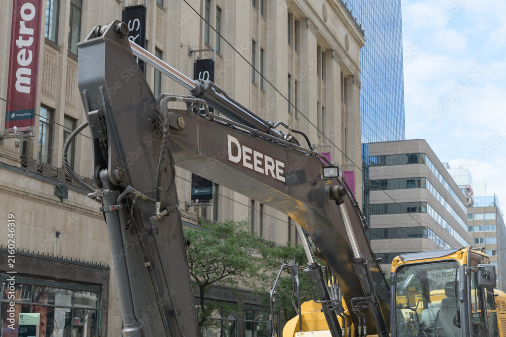 Fototapeta premium Deere heavy construction equipment outside College Park (near the streetcar track replacement/renewal at the intersection of Yonge St and College/Carlton), Toronto