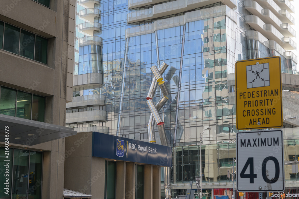 Fototapeta premium wide view of intersection at Yonge and Bloor (RBC Royal Bank at 2 Bloor St E) with view of Ron Arad sculpture, 
