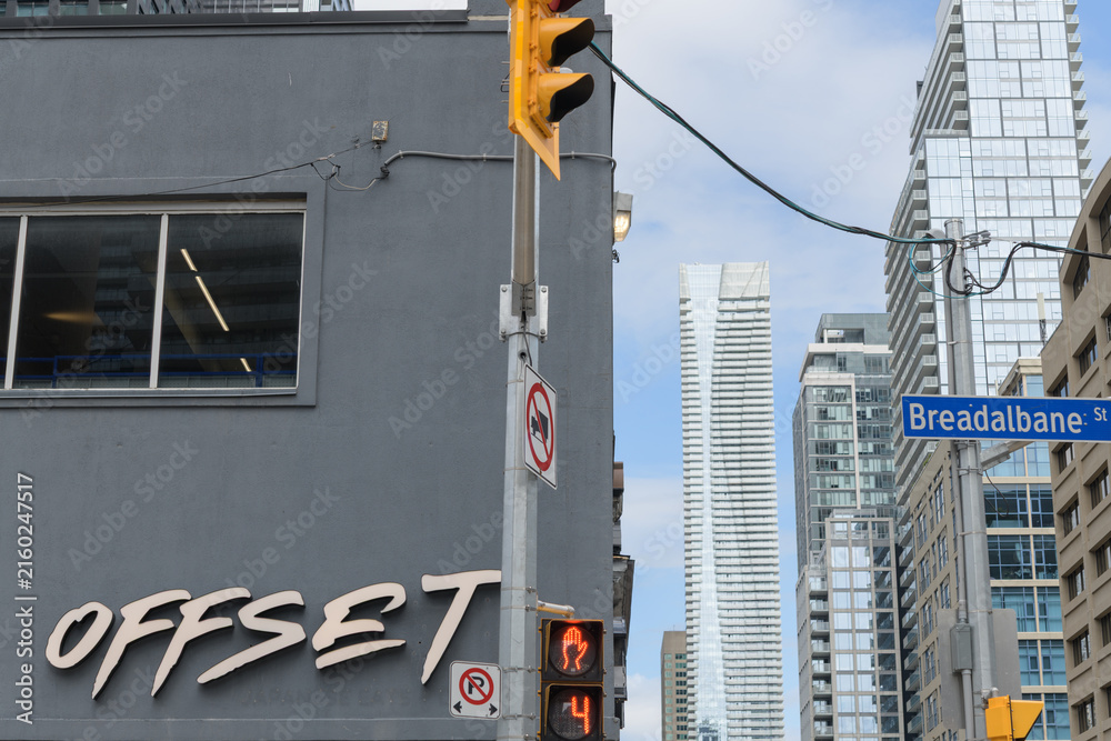 Fototapeta premium looking north on Yonge St to sign outside Offset Bar / Café and (in the distance) One Bloor East from Breadalbane St, Toronto