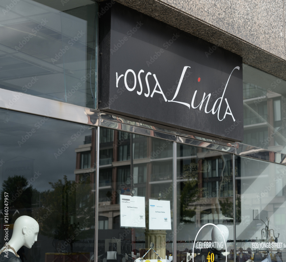 Fototapeta premium exterior building facade and sign over entrance to rossaLinda Boutique, a clothing store, located at 1920 Yonge St, Toronto