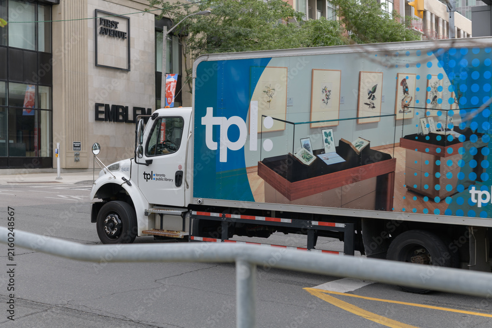 Fototapeta premium box truck with TPL or Toronto Public Library branding, heading north on Yonge St