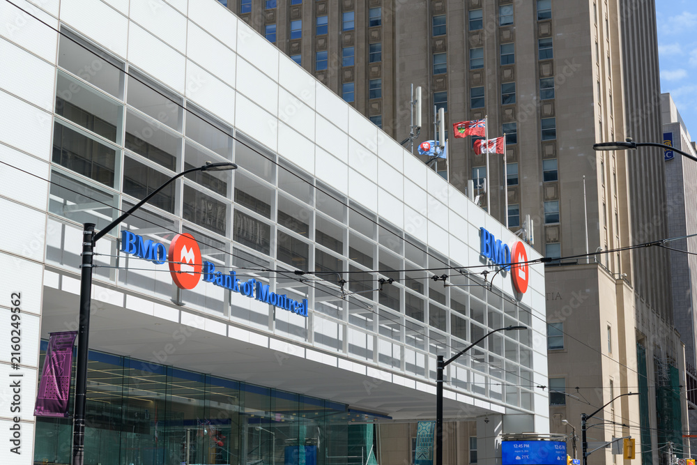 Fototapeta premium wide, perspectival view of BMO Bank of Montreal signage outside south pavilion of First Canadian Place at northwest corner of King and Bay, Toronto