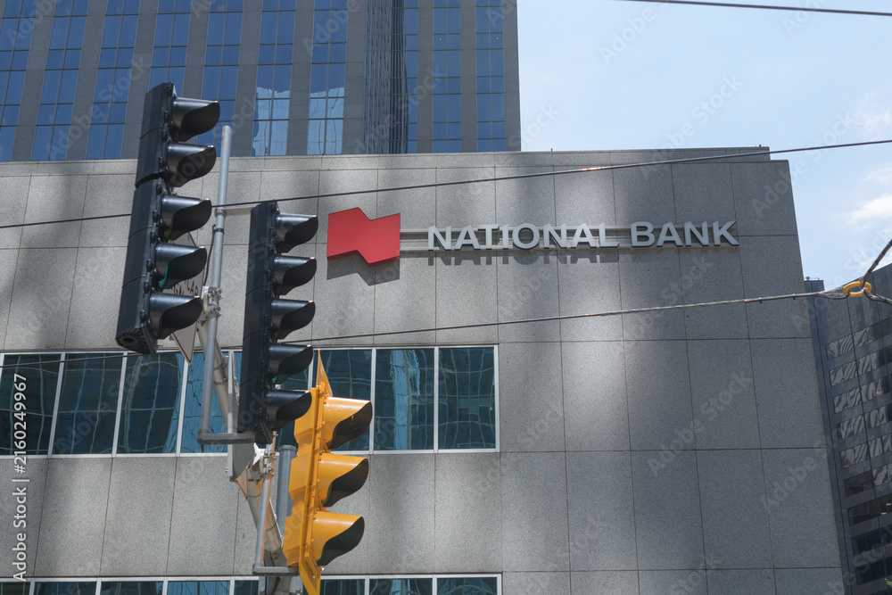 Fototapeta premium exterior building facade and sign of National Bank, a financial institution, located in Roserock Place, 121 King St W, Toronto