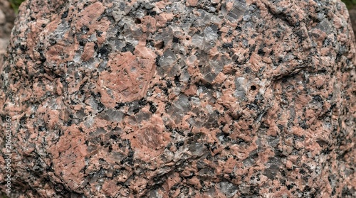 Detailedshot of a robust natural granite stone surface with intricate mineral speckles in gray pink and black crystalline patterns granite stone texture pillar natural surface rock