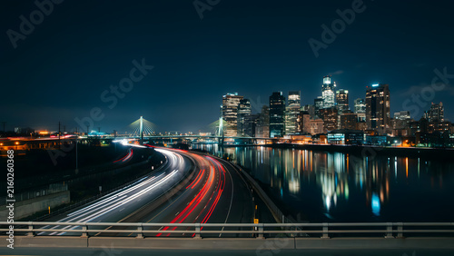 Night City Skyline With Curving Highway Light Trails and Urban Traffic Long Exposure