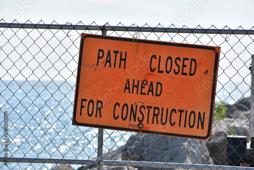Construction path closed ahead orange sign