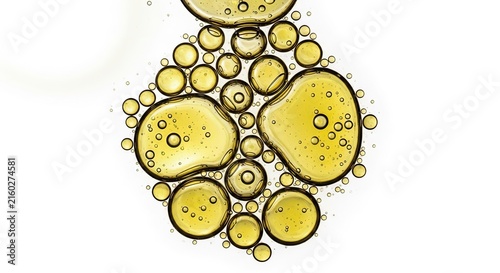 The image displays a macro photograph of a golden oil droplet, revealing a complex network of smaller bubbles within.