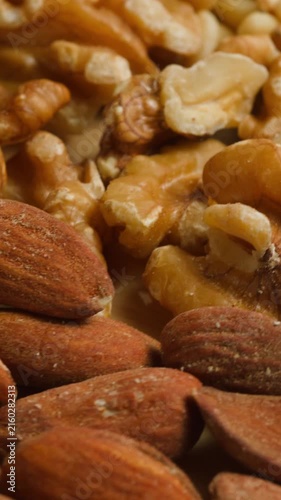 Nuts mix of pecan walnut cashew hazelnut pine and Brazil nuts with peanut on wooden table healthy snack close-up