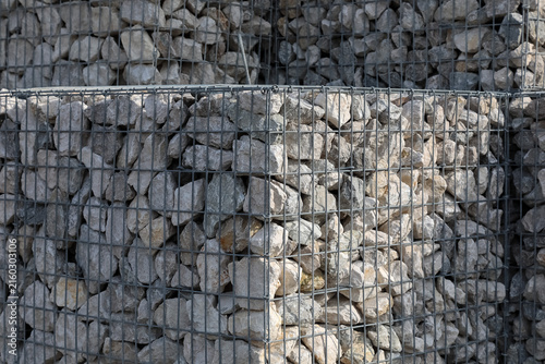 Foto Cubic gabions filled with stones create a wall