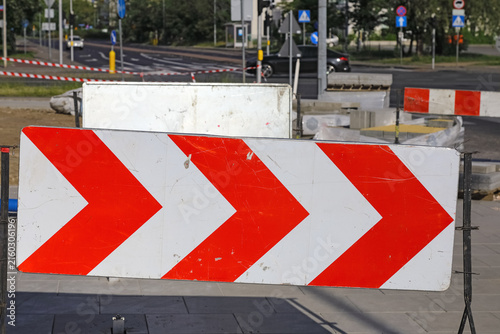 This red-and-white protective barrier shows the route that pedestrians should take around the construction site