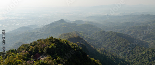 Obraz na plátne Scenic mountain landscape surrounding Doi Tung, Chiang Rai, with forested hills, distant valleys, and hazy mountain ranges