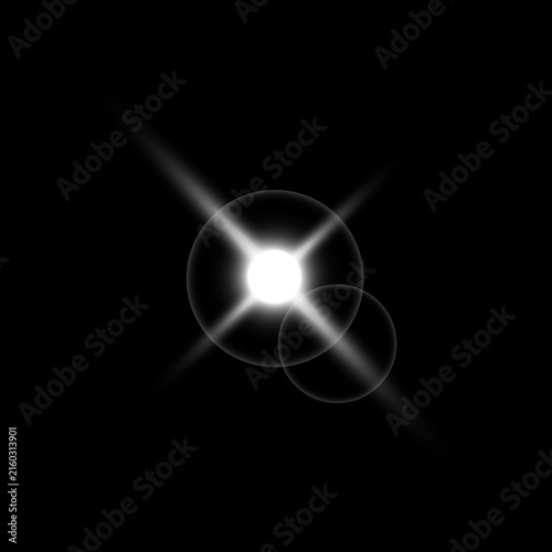 Fotografie Dramatic lens flare a brilliant starburst effect on a dark black background for
