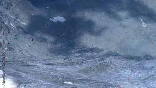 Zipline Rider Above Tortin Glacier and Cloud Shadows