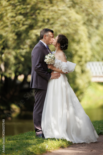 Loving Wedding Couple Outdoor Portrait in Natural Sunlight, Bride and Groom