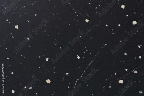Dark terrazzo surface with white veining ideal for product staging and flatlays