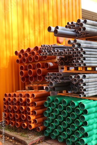 Foto Colorful stacked pipes in a warehouse