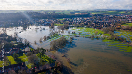 Aerial view of the flooded Queen Elizabeth Gardens and the River Avon in Salisbury, with the Salisbury Cathedral spire visible in the distance, Salisbury, Wiltshire, United Kingdom.