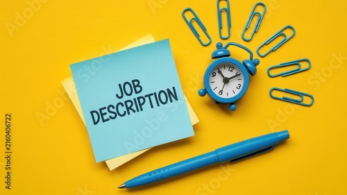 Job Description text on sticky note with alarm clock and office supplies on yellow background