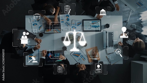 Canvas Print A high-angle view of a business meeting in a modern conference room focusing on legal symbols, technology, and teamwork among professionals surrounded by charts and data