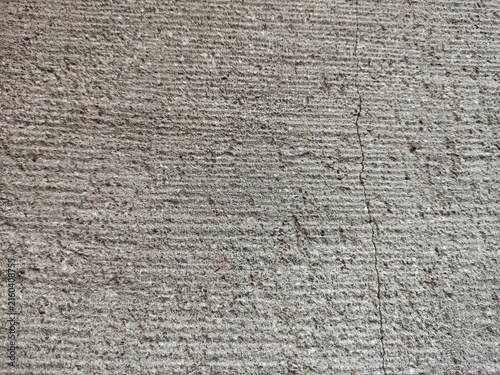 Close-up texture of an old weathered concrete wall with a crack